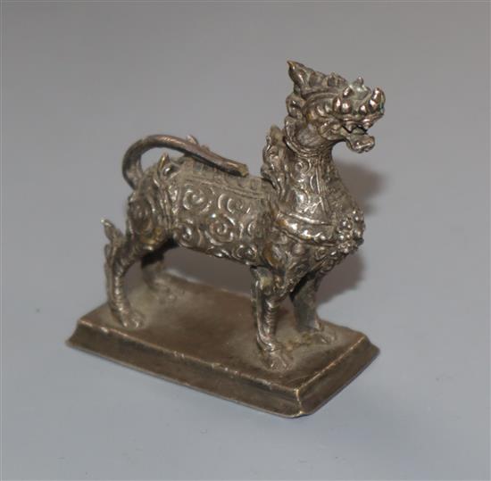An Indonesian white metal model of a lion, height 55mm.